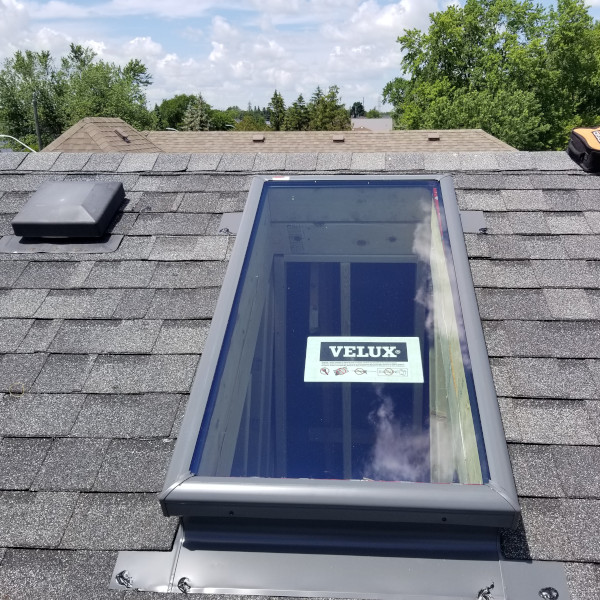 An image of a new roof skylight with Velux sticker on the glass.