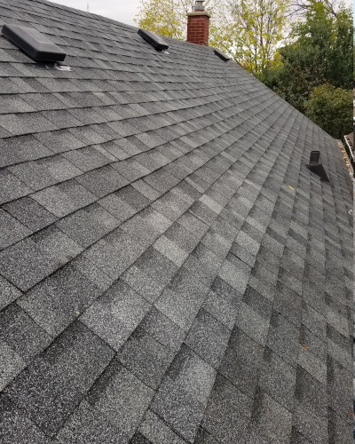 An image of roof of a house with fixed shingle.