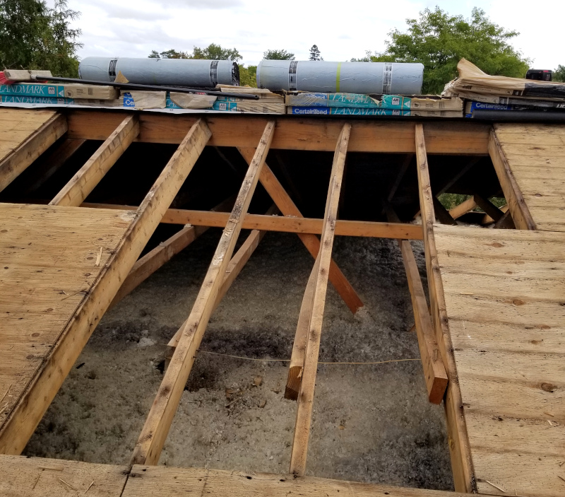 An image of a roof with exposed woods and sides, ready for new roof.